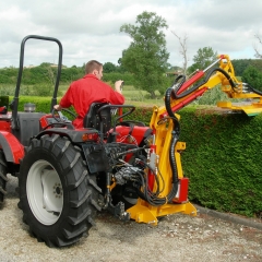 Hedge cutter on micro tractor